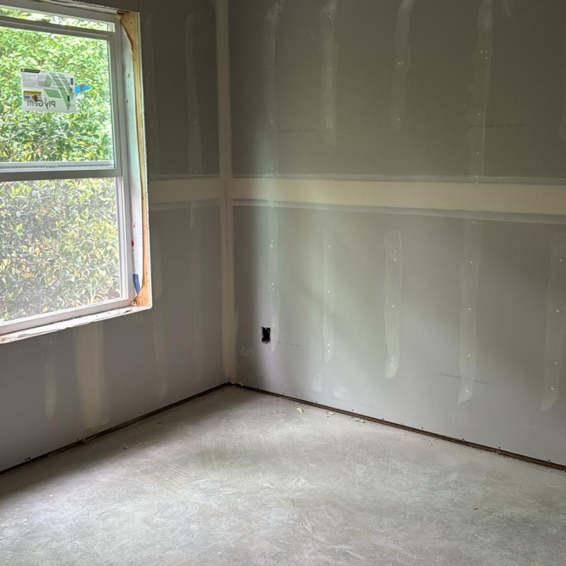 Drywall contractor installing sheetrock