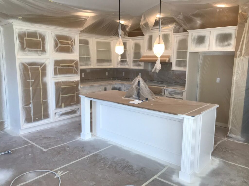 Cabinet refinishing contractor applying finish coat