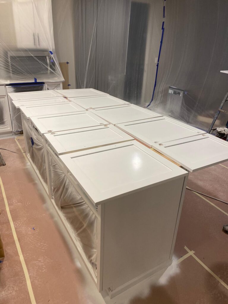 Refinished kitchen cabinets with new hardware