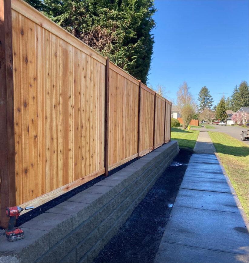Fence builder installing new fence posts